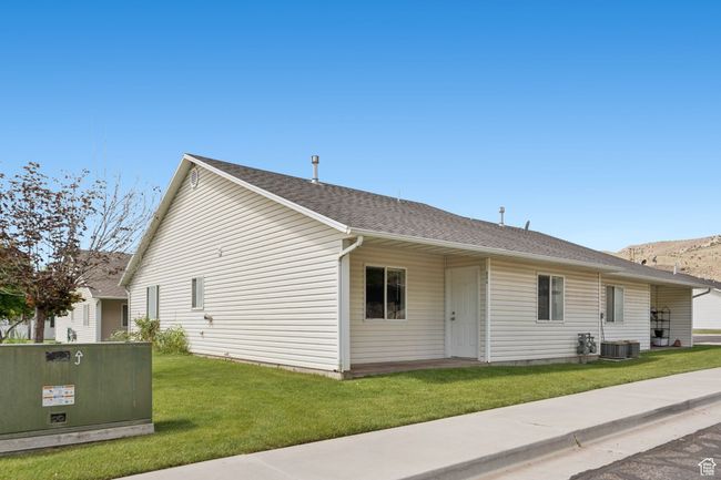 View of property exterior featuring a yard and roof with shingles | Image 24
