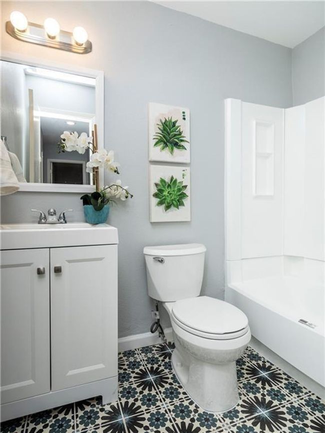 Bathroom featuring vanity, shower / tub combination, and tile patterned flooring | Image 5
