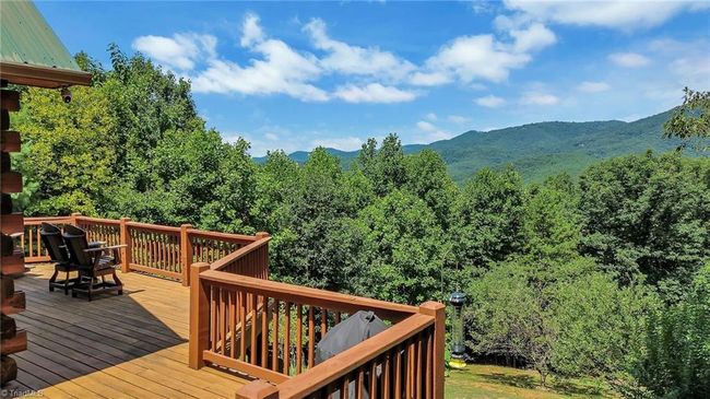 Capture breathtaking views of the North Carolina mountains from the expansive deck of this rustic cabin, where tranquility meets panoramic beauty. | Image 8