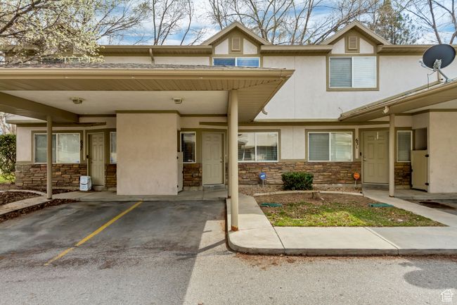 View of property with stone siding, an attached carport, and stucco siding | Image 18