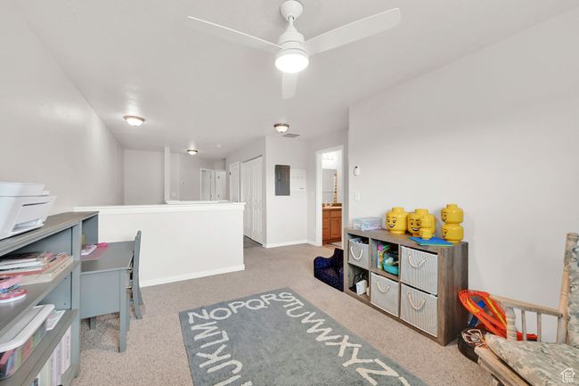 Recreation room featuring electric panel, baseboards, and ceiling fan | Image 11