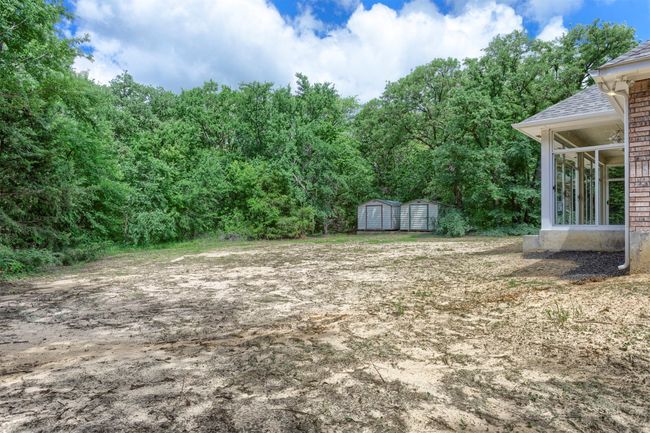 View of yard featuring a storage shed and an outdoor structure | Image 30