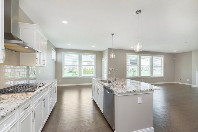 kitchen with exterior exhaust hood, wood flooring, stainless appliances | Image 4