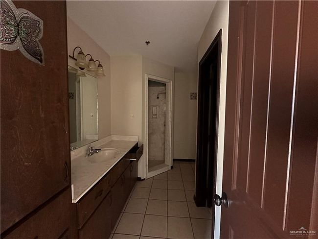 Bathroom with vanity, walk in shower, and tile patterned flooring | Image 6