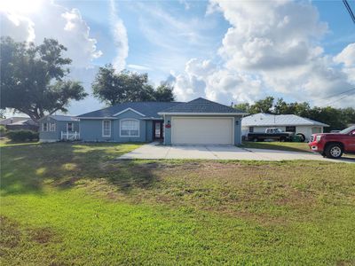 Driveway provides access to garage from the south side of lot; potential for circular driveway | Image 2