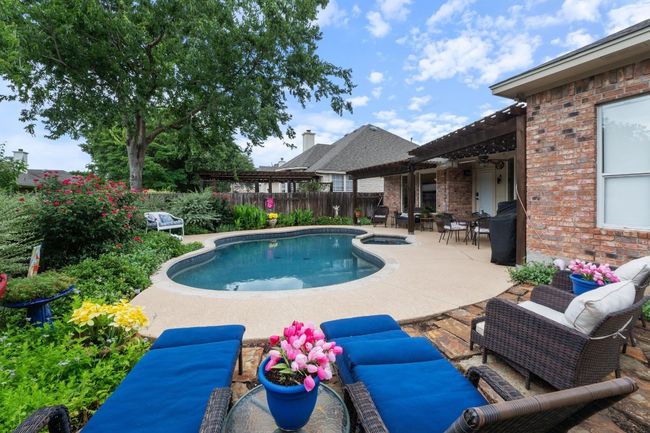 View of pool featuring a pergola, fenced backyard, outdoor dining area, and a pool / hot tub. | Image 34