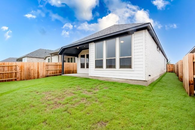 Rear view of property featuring a patio and a shingled roof | Image 31