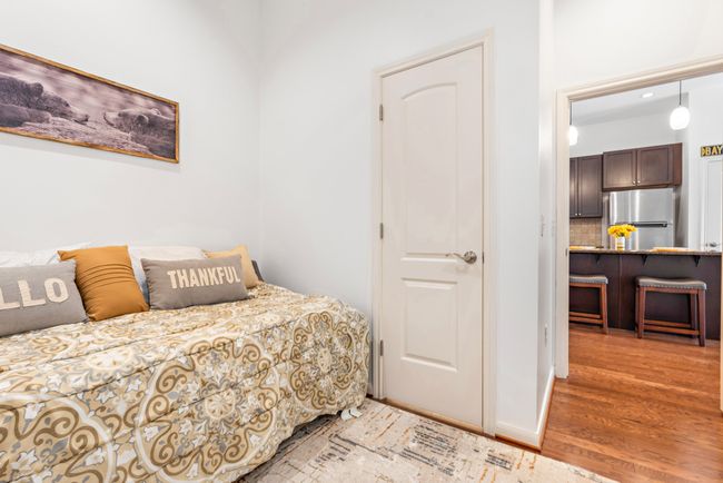 Bedroom with freestanding refrigerator and light wood finished floors | Image 12