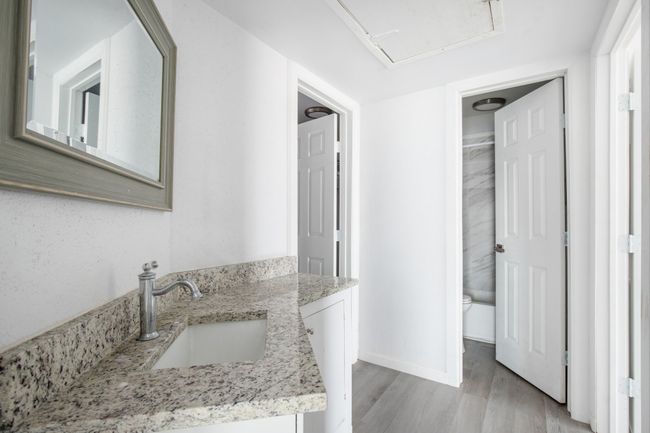 Bathroom featuring toilet, wood-type flooring, and vanity | Image 15