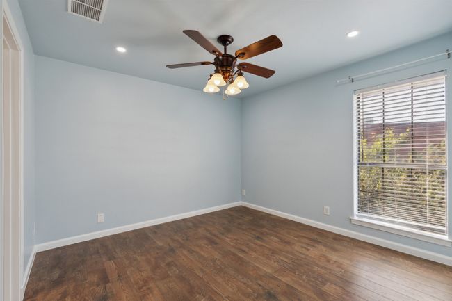 Unfurnished room UPSTAIRS featuring wood-style flooring, recessed lighting, visible vents, and baseboards | Image 15
