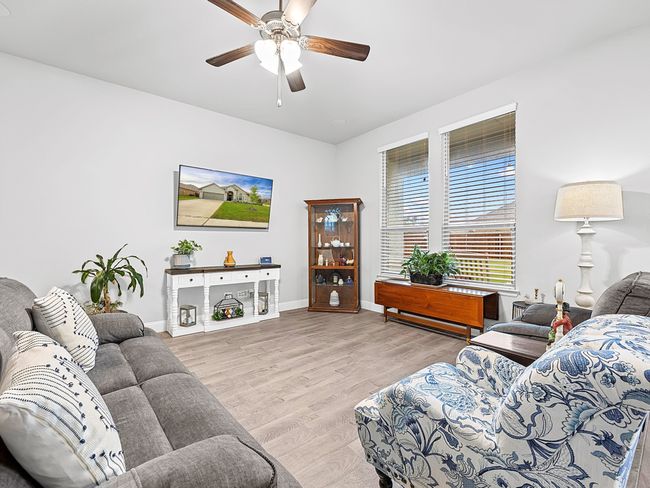 Living room with a ceiling fan and wood finished floors | Image 4