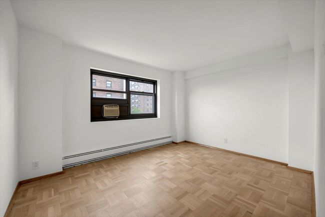 Empty room with baseboard heating and cooling unit | Image 9