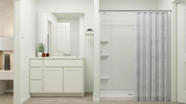 Bathroom featuring a shower with shower curtain, wood finished floors, and vanity | Image 6
