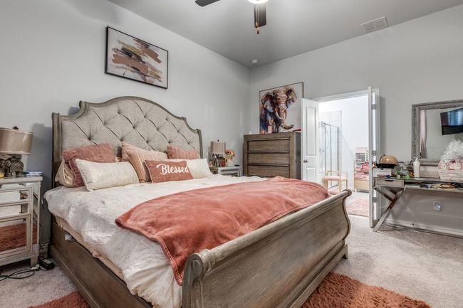 Bedroom featuring light colored carpet and ceiling fan | Image 12