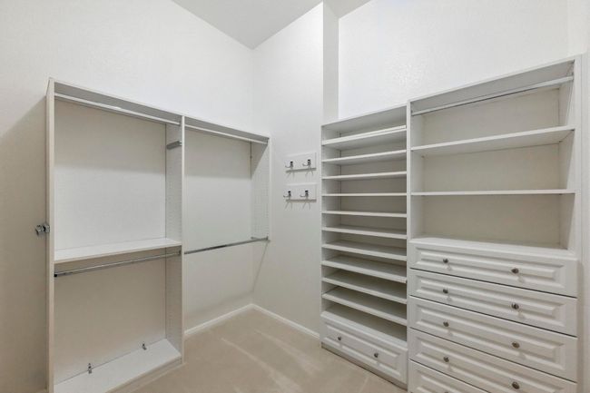 Primary walk in closet featuring new carpet and custom built-ins. | Image 23