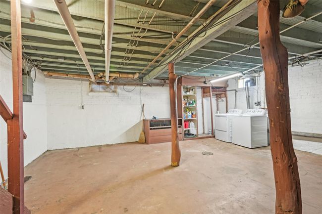 Unfinished below grade area featuring washer and clothes dryer | Image 32