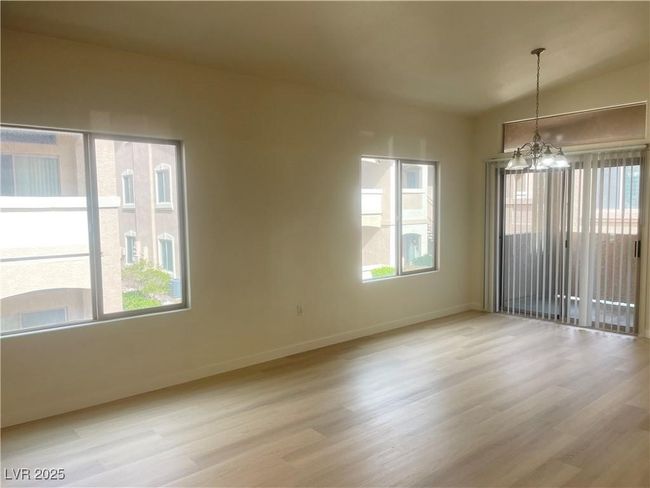 Spare room with a chandelier, healthy amount of natural light, and light wood-type flooring | Image 7