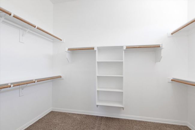 Walk in closet featuring carpet | Image 23