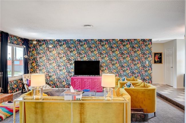 Living area featuring a textured ceiling, carpet, baseboards, and wallpapered walls | Image 12