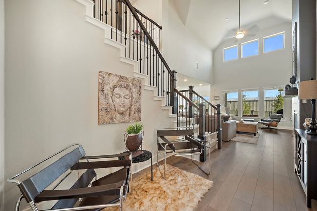 Staircase with high vaulted ceiling, hardwood / wood-style floors, and a ceiling fan | Image 10