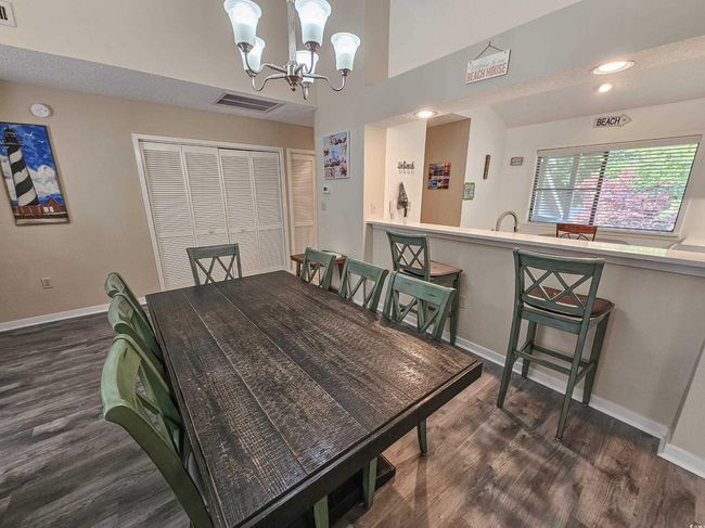 Dining space featuring baseboards, dark wood-type flooring, a chandelier, and recessed lighting | Image 18