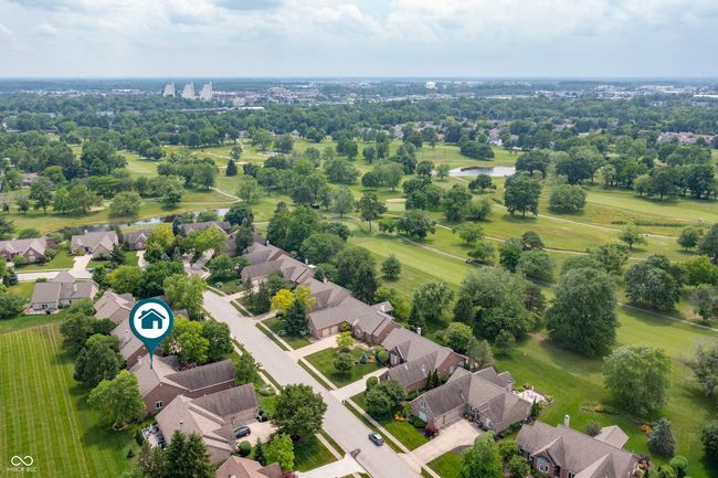aerial perspective of suburban area with a large body of water and a tree filled landscape | Image 33