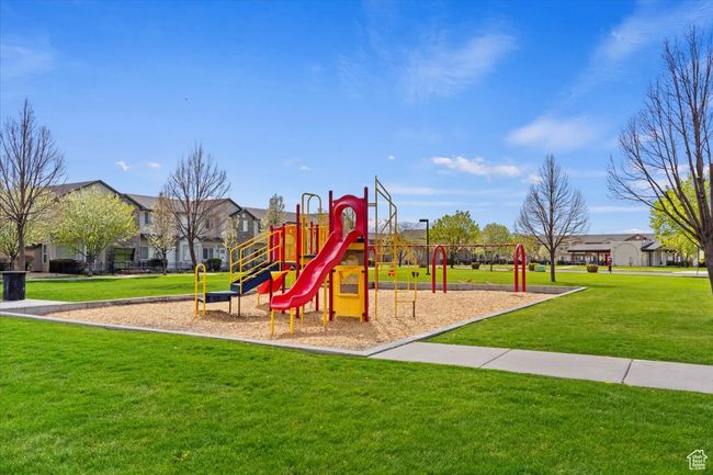 Communal playground featuring a yard and a residential view | Image 33