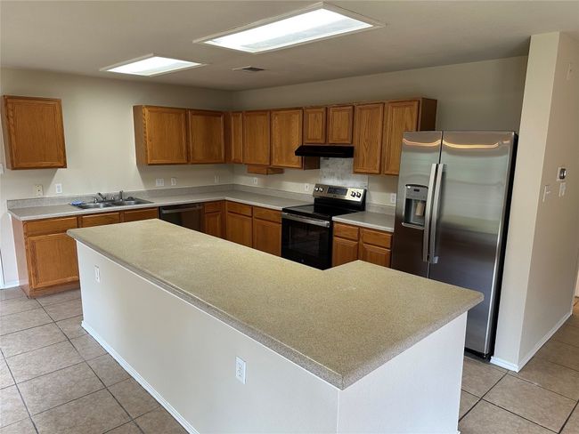 The kitchen island is much larger in person! | Image 26