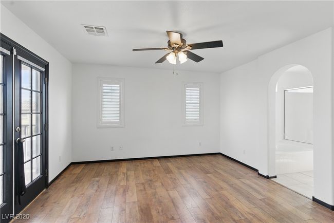 Primary bedroom with arched walkways and access to the balcony | Image 14