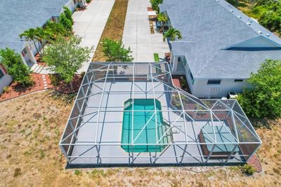 Condo private pool in screened area plus a hot tub and plenty of sitting for entertaining. | Image 2