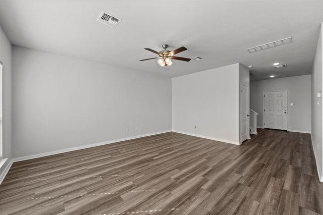 Unfurnished room featuring wood-look tile flooring and a ceiling fan | Image 5