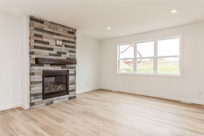 (Photo is of an inventory home, actual homes finishes will vary) Stay warm with the beautiful gas fireplace in the great room. | Image 3