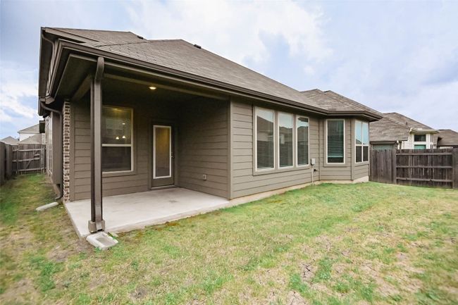 Back of property featuring a fenced backyard, a patio area, and a lawn | Image 6
