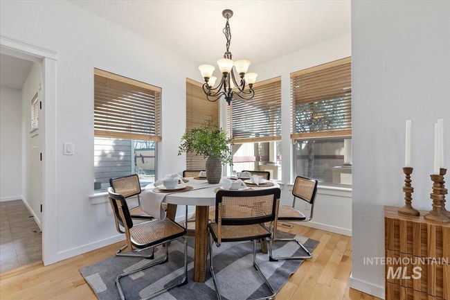 Dining room featuring light wood-style flooring and a chandelier | Image 25