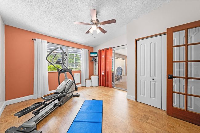 Main Home - Bedroom 3 that has a sliding glass door that leads to the pool. | Image 51