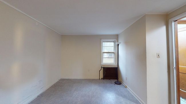Unfurnished room featuring radiator heating unit | Image 18