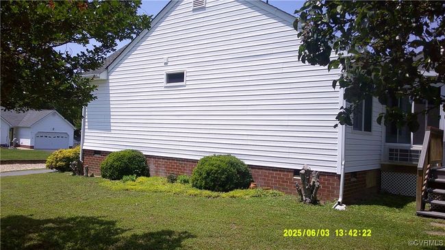View of property exterior featuring crawl space and a yard | Image 5