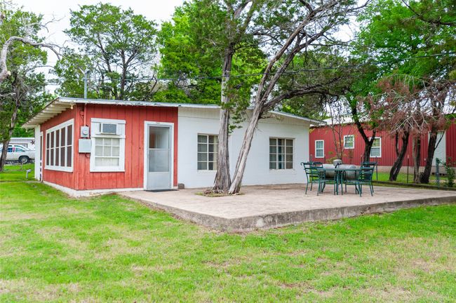 Back of house with a patio, board and batten siding, and a lawn | Image 6