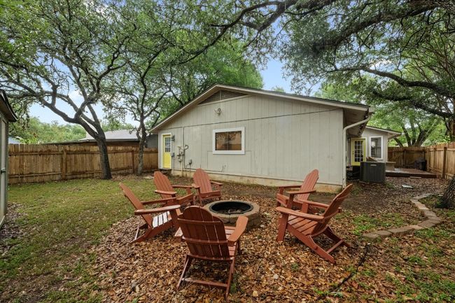 Rear view of property featuring a fire pit and a fenced backyard | Image 28