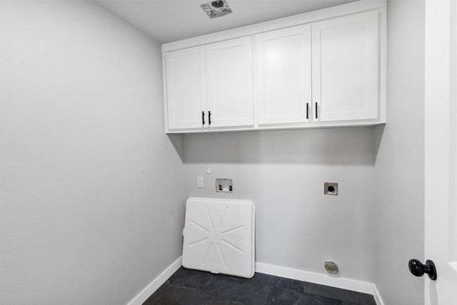 Laundry area with hookup for an electric dryer, baseboards, cabinet space, and hookup for a washing machine | Image 30