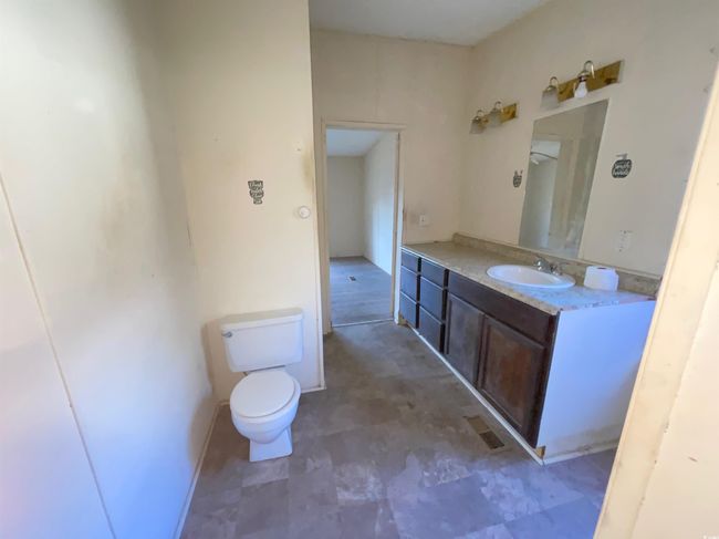 Bathroom with toilet, vanity, and visible vents | Image 11