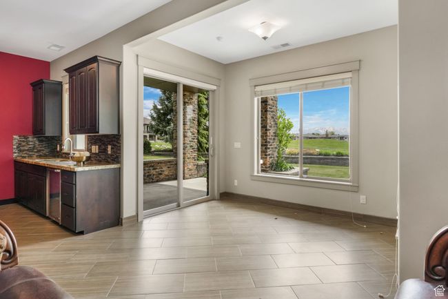 Doorway featuring baseboards, visible vents, and a sink | Image 15