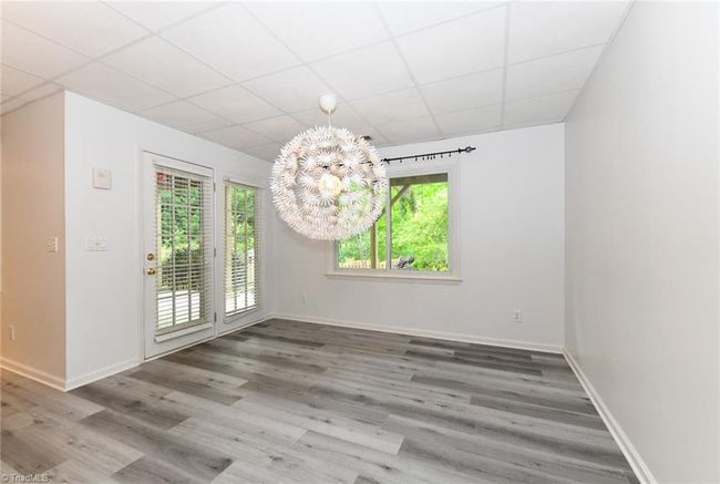Dining room with a modern chandelier and walk out to a private patio | Image 33