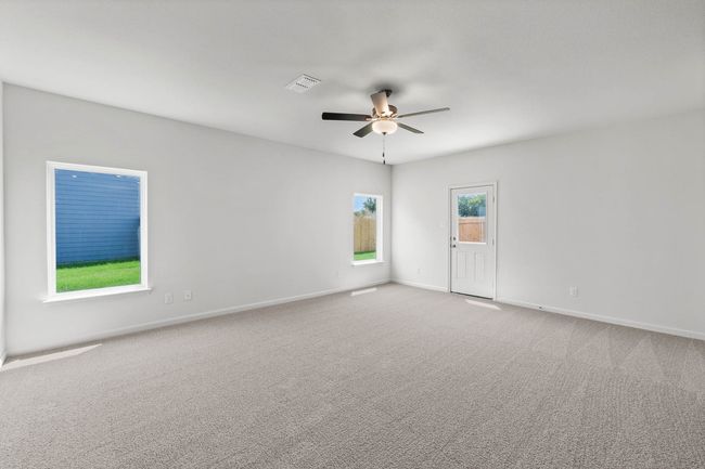 Unfurnished room with light colored carpet and a ceiling fan | Image 5