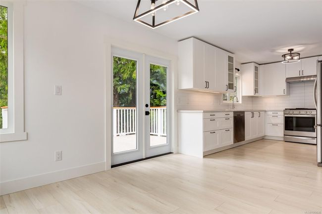 Kitchen and dining area with access to back deck | Image 17