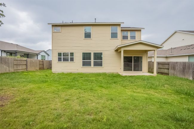 Rear view of house featuring a lawn, a fenced backyard, and a patio area | Image 32