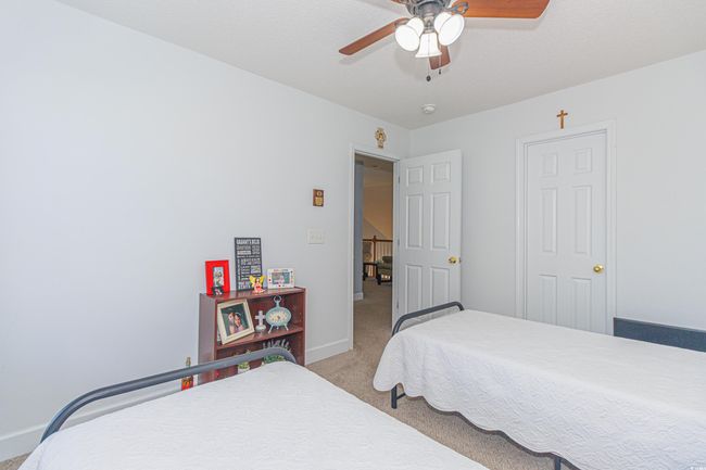 Carpeted bedroom featuring ceiling fan | Image 26