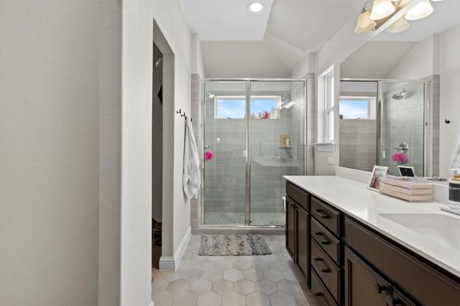 Bathroom with vanity, a stall shower, tile patterned floors, and lofted ceiling | Image 21