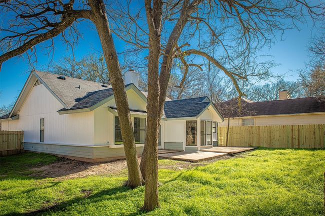 Spacious yard with mature trees and room to entertain. | Image 17