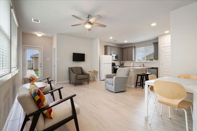 Furnished Living area featuring finished floors, a ceiling fan, and recessed lighting | Image 5